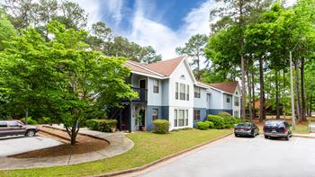 Two story residential building with parking area